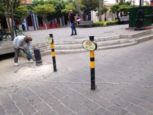 Workers were installing bollards to prevent people from driving down Constitución along Plazuela Machado.