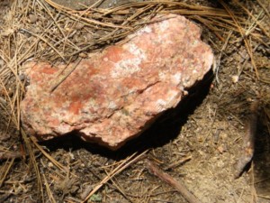 Lots of orthoclase feldspar (a reddish/pinkish quartz) abounded).