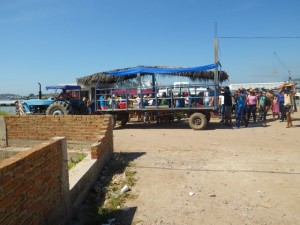 Gobs of (Mexican) tourists) getting on a tour tractor.